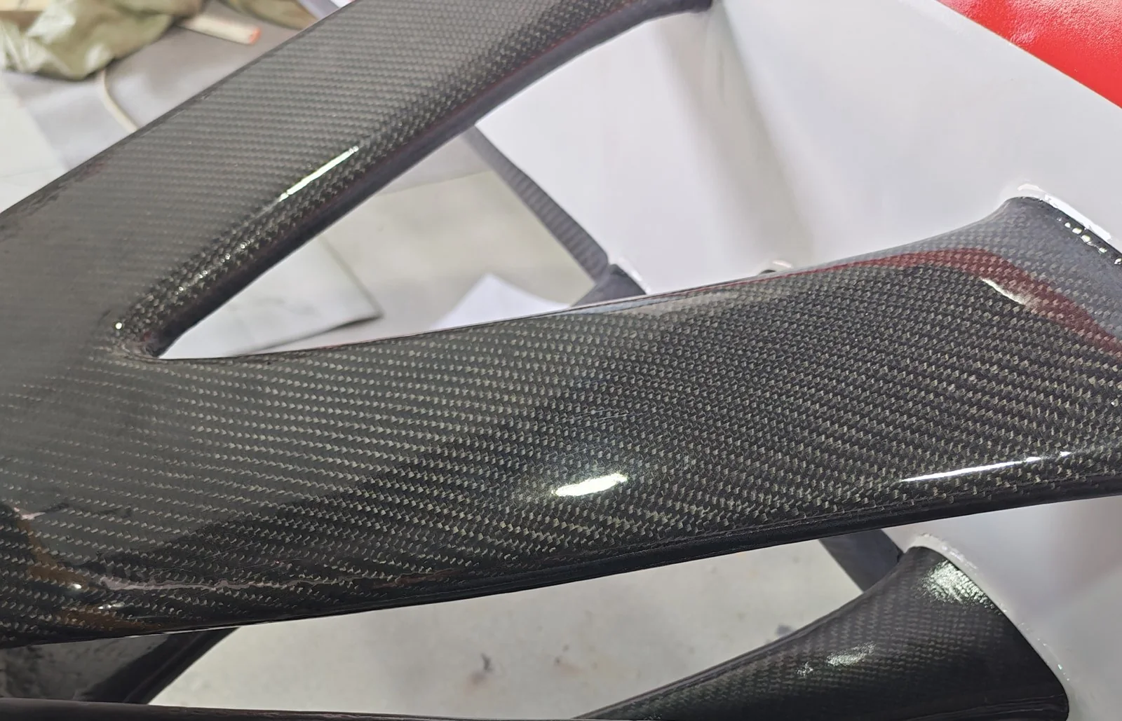 Close-up of a glossy carbon-cloth panel